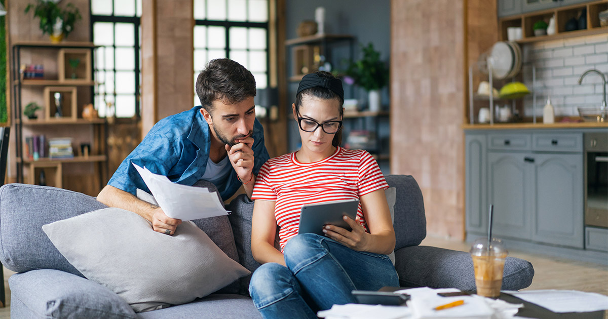 A couple reviews current trends in the housing market. They are preparing to buy a new home.